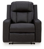 Black zero-wall recliner with tufted headrest, wide arms, and smooth front panel