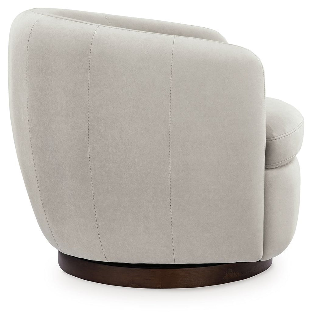 Light beige swivel accent chair side view with rounded back and dark brown base