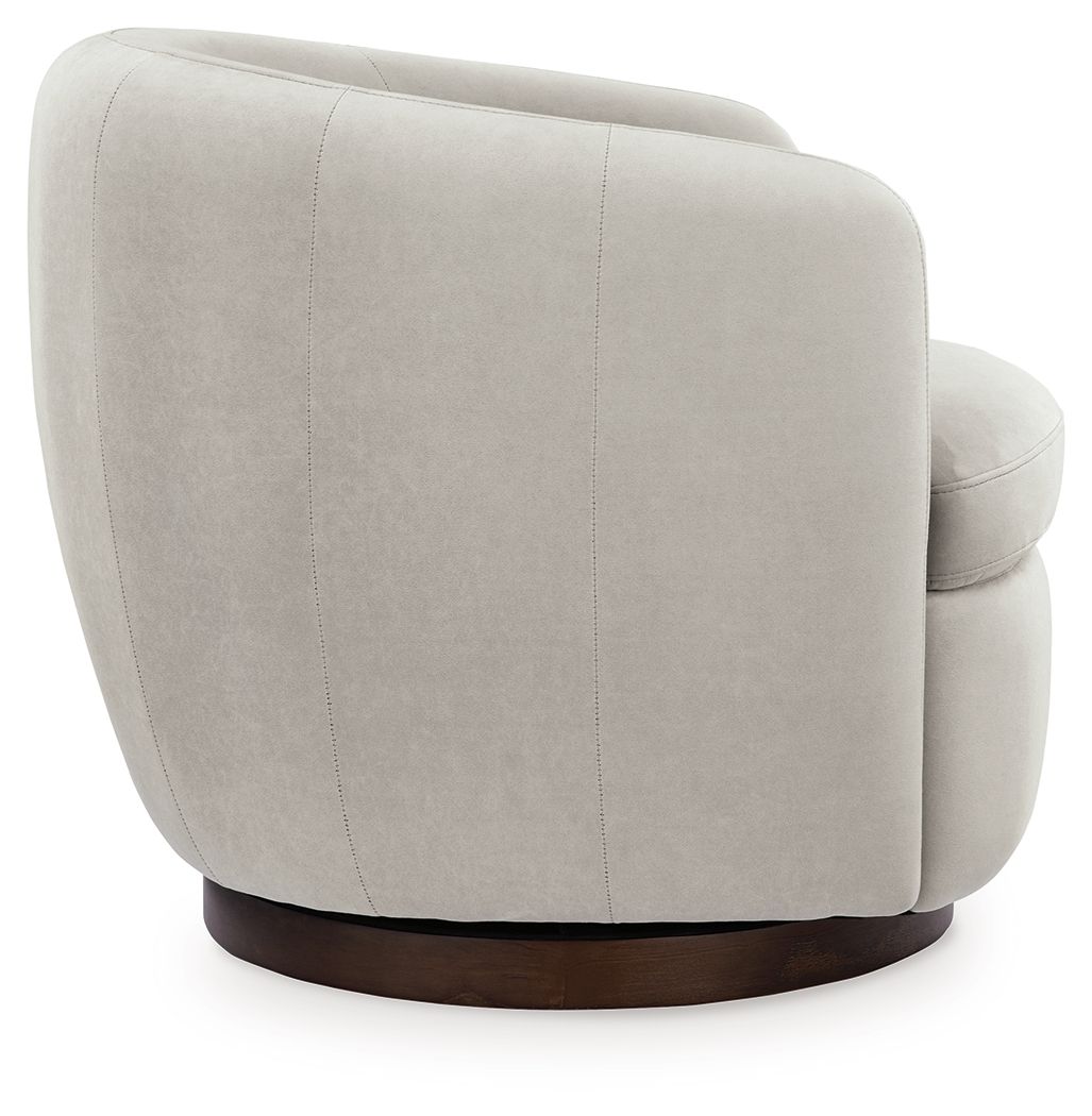 Light beige swivel accent chair side view with rounded back and dark brown base