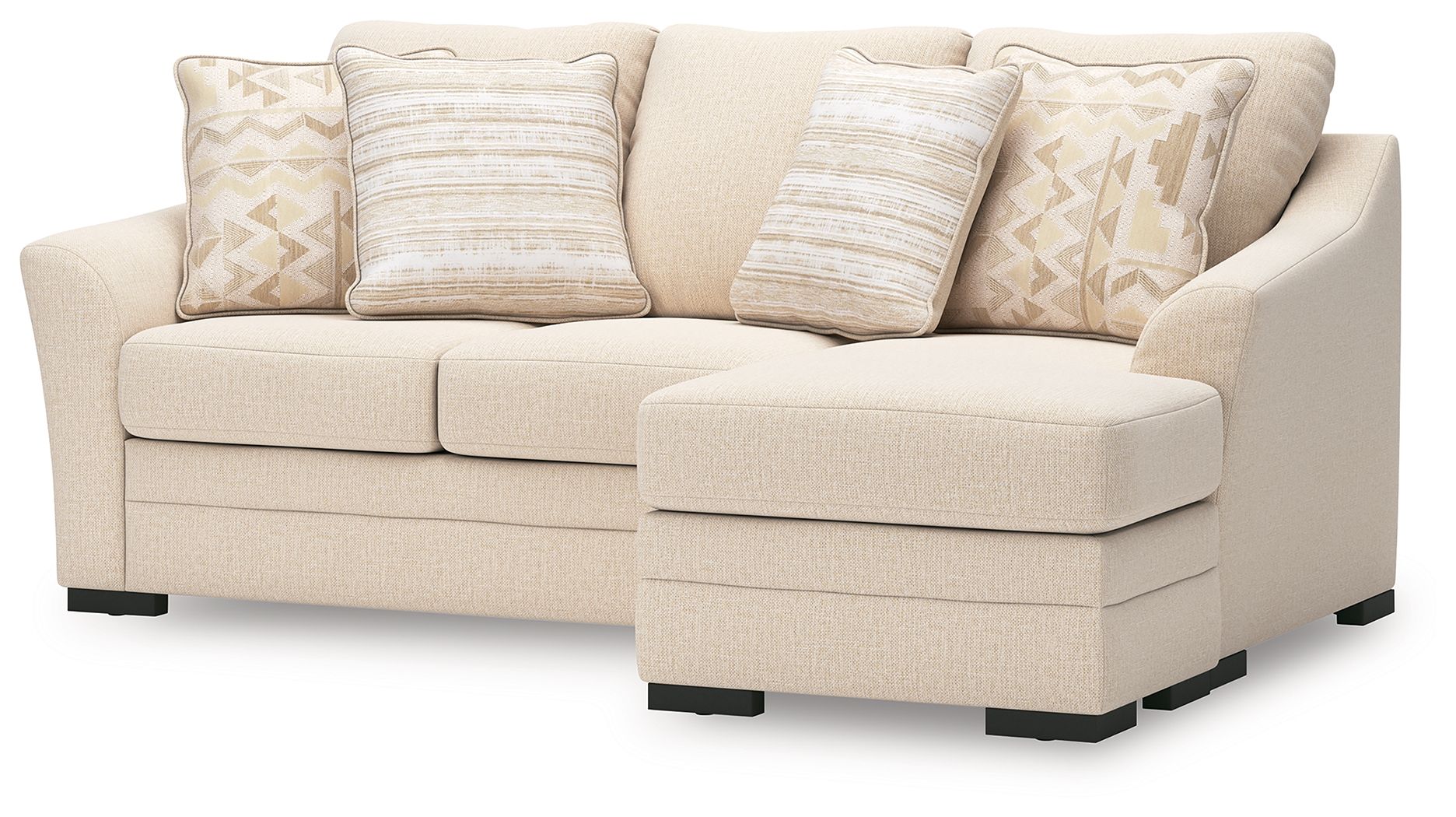 Light beige sofa chaise with throw pillows, rounded arm corner, and dark base feet.