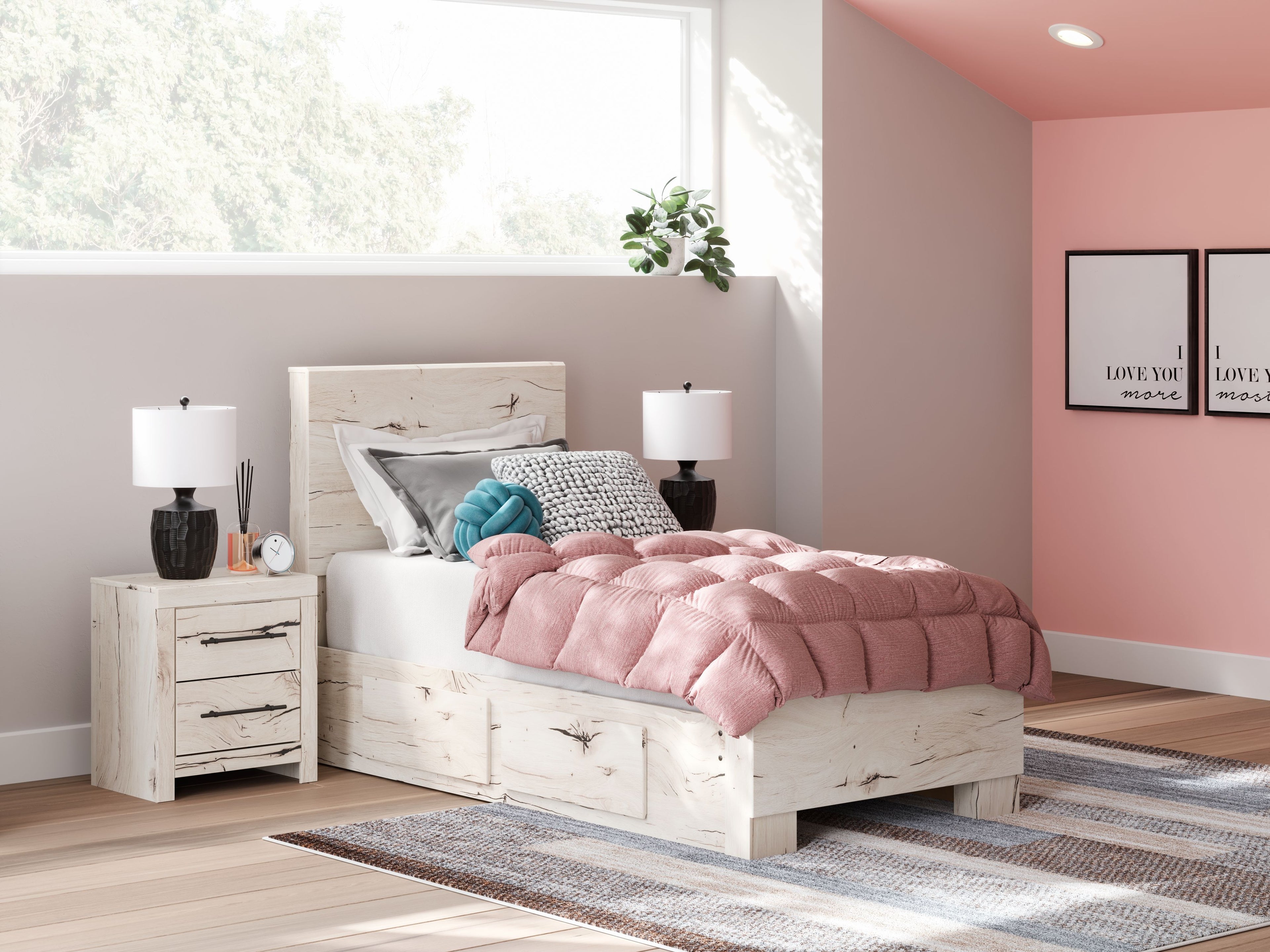 Light wood panel bed with storage drawers, pink quilt and gray pillows