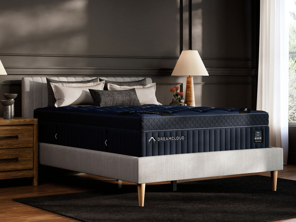 DreamCloud Blue hybrid mattress on a bed frame with visible legs