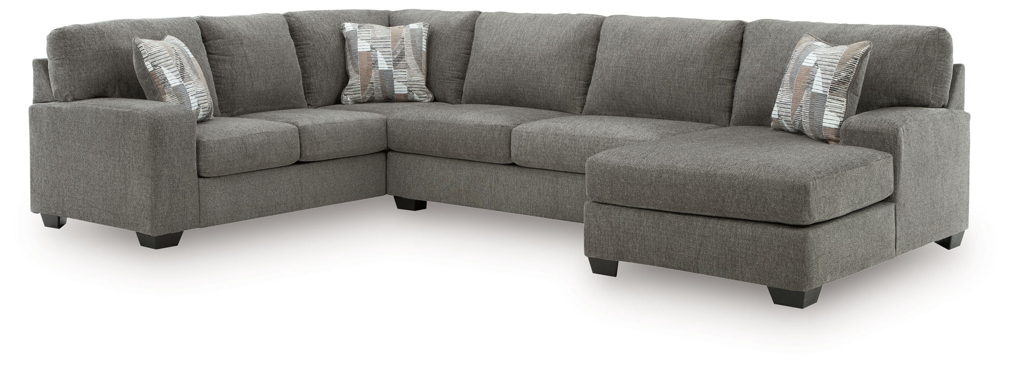 Gray sectional sofa with chaise and tufted back cushions, square arms, accent pillows