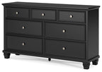 Black dresser with six drawers and round silver knobs, rectangular frame, tapered feet