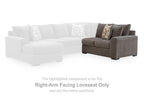 Gray right-arm loveseat in corner seating, styled with patterned and solid throw pillows.