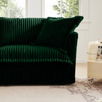 Green corduroy sectional sofa with rounded arms and deep cushioned backrest