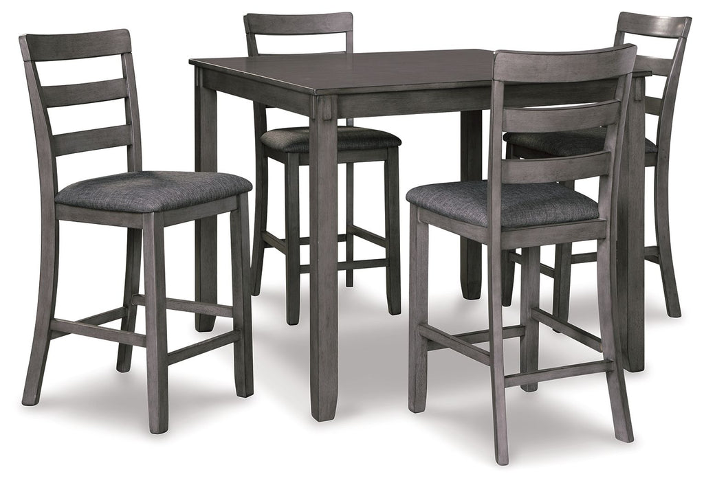 Square counter table with four dark gray upholstered bar stools, angled view.