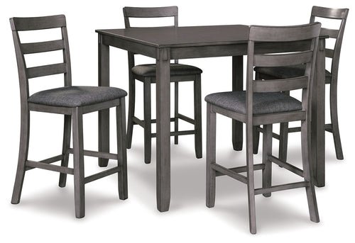 Square counter table with four dark gray upholstered bar stools, angled view.