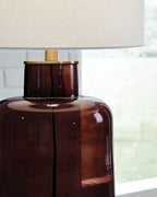 Brown amber glass table lamp with white shade and gold metal collar