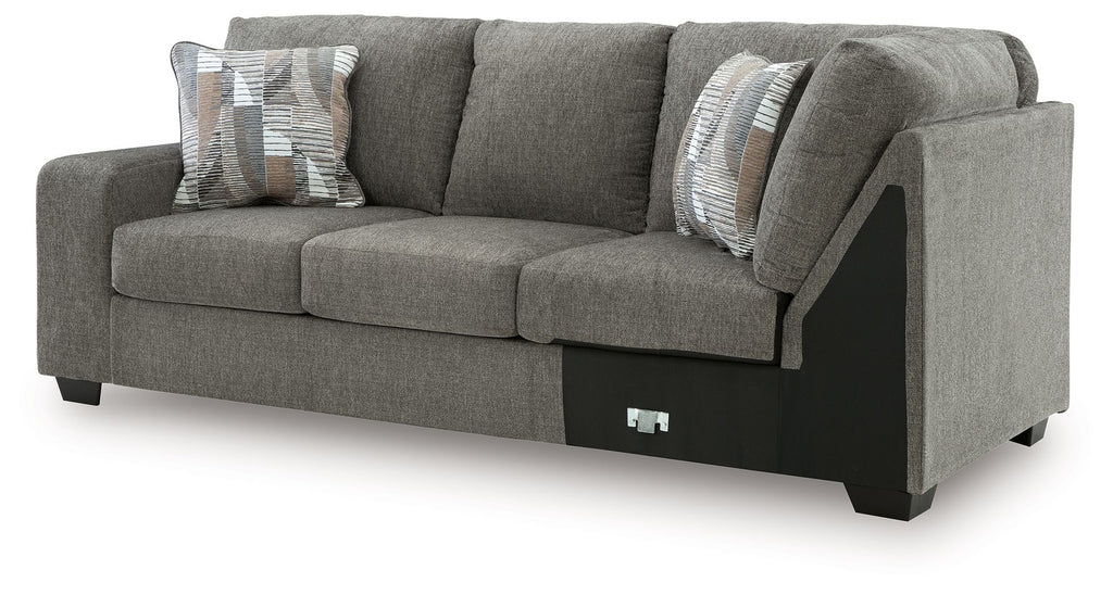 Greystone gray LAF sofa with corner wedge, box cushions, and two patterned throw pillows