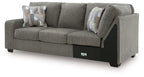 Greystone gray LAF sofa with corner wedge, box cushions, and two patterned throw pillows