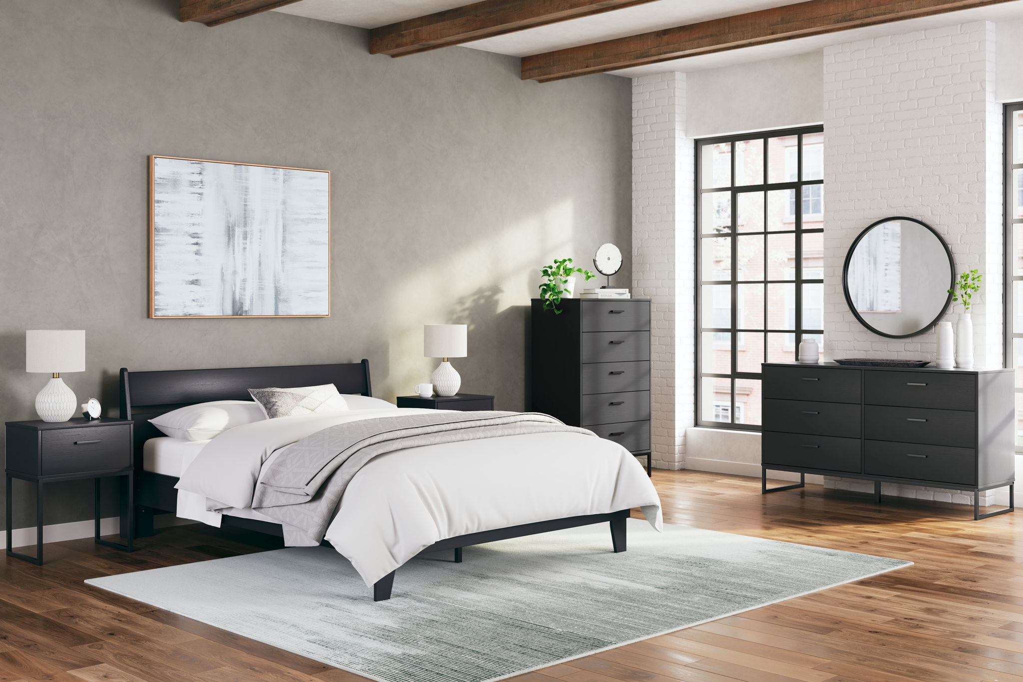 Bedroom set with black bed, dresser, round mirror, and bedside tables