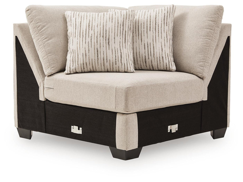 Upholstered wedge armchair with light beige fabric and two accent pillows