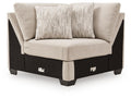 Upholstered wedge armchair with light beige fabric and two accent pillows