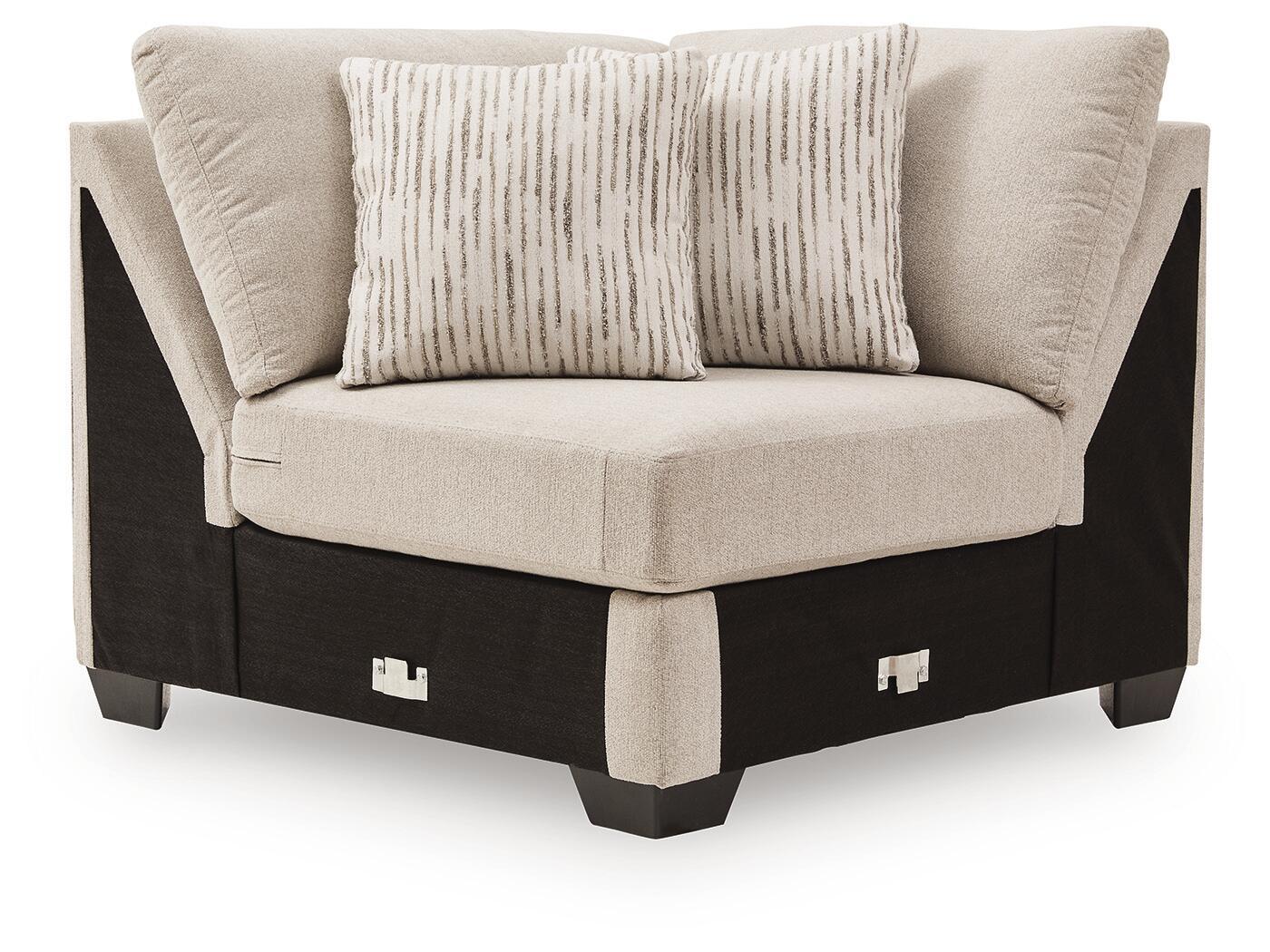 Upholstered wedge armchair with light beige fabric and two accent pillows