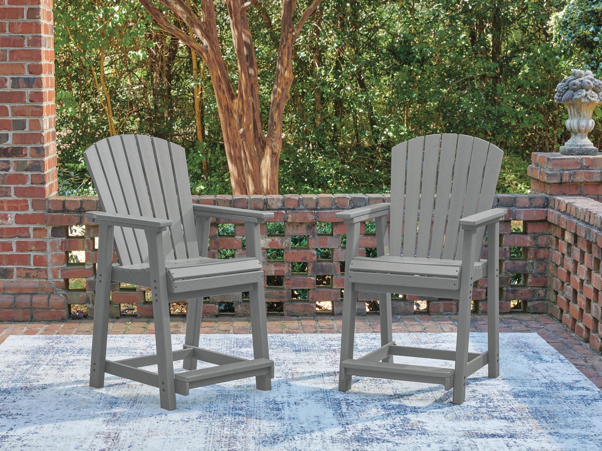 Pair of dark gray wooden barstools with slatted backs, armrests, and wide seat.