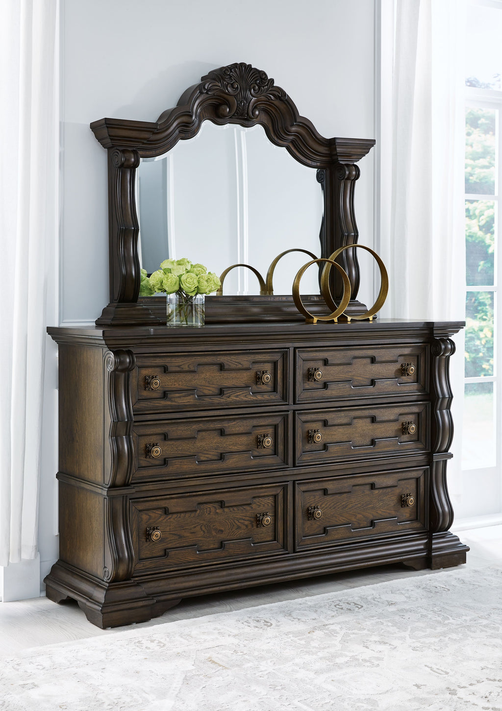 Dark brown dresser with arched mirror, six drawers, decorative knobs and legs