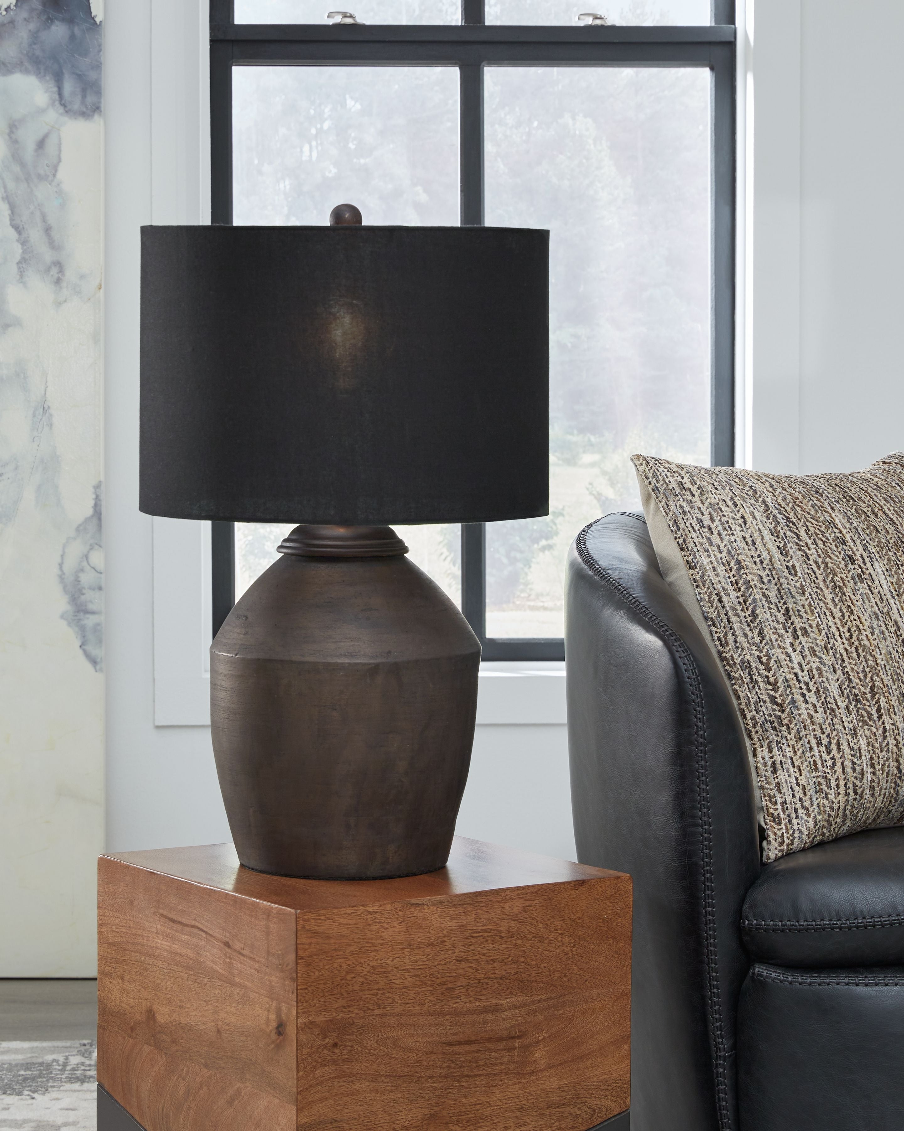 Table lamp with black fabric shade on stacked dark bronze base