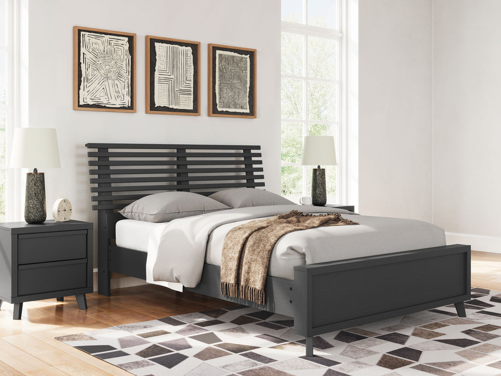 Black full slat panel bed with pillows, throw blanket, and slatted headboard