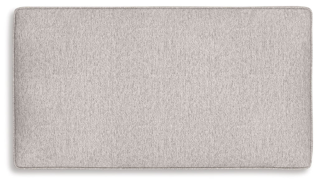 Sandstone fabric ottoman with rectangular padded top and stitched edges