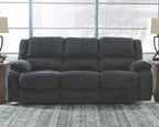 Dark gray reclining sofa with squared cushions and padded track arms