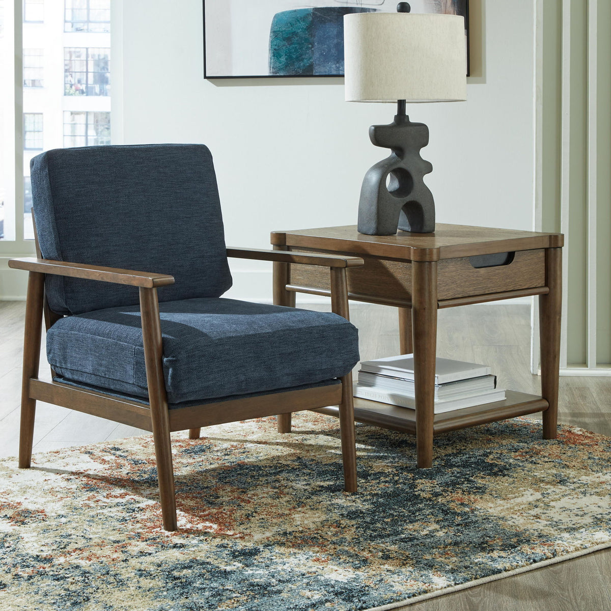 Blue upholstered accent chair with wooden arms and legs