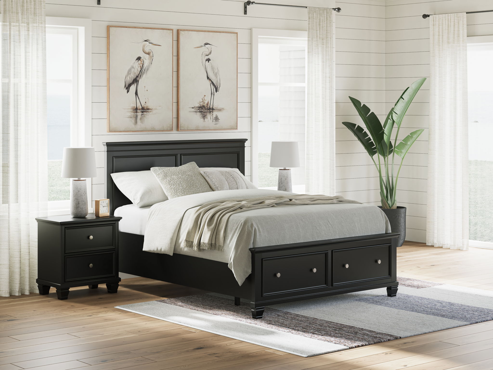 Black panel bed with paneled headboard and drawers at the footboard; made bed