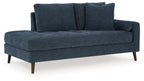 Blue corner chaise sofa with two back cushions and tapered wooden legs