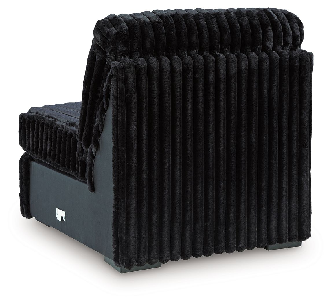 Armless chair angled view with ribbed black upholstery and low arm panels