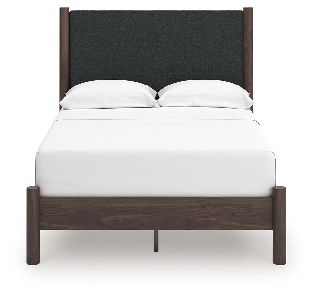 Upholstered panel platform bed with dark headboard, white mattress, and two pillows
