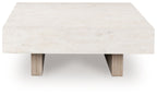Rectangular table with pale stone top and two visible wood supports