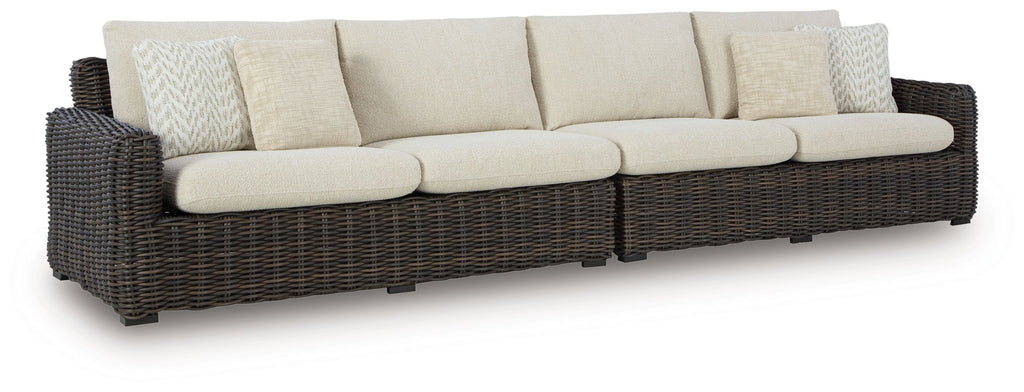 Dark brown wicker loveseat with beige seat and back cushions, removable throw pillows