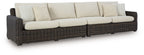 Dark brown wicker loveseat with beige seat and back cushions, removable throw pillows