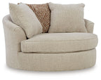 Oversized swivel accent chair in light beige fabric with rounded arms and thick seat