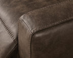Brown upholstered sofa armrest with visible edge stitching and curved seam
