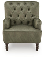 Green velvet-look accent chair with tufted diamond back, rounded arms, and dark wood feet.