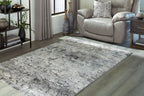 Dark gray distressed area rug, flat profile with stitched border and corner