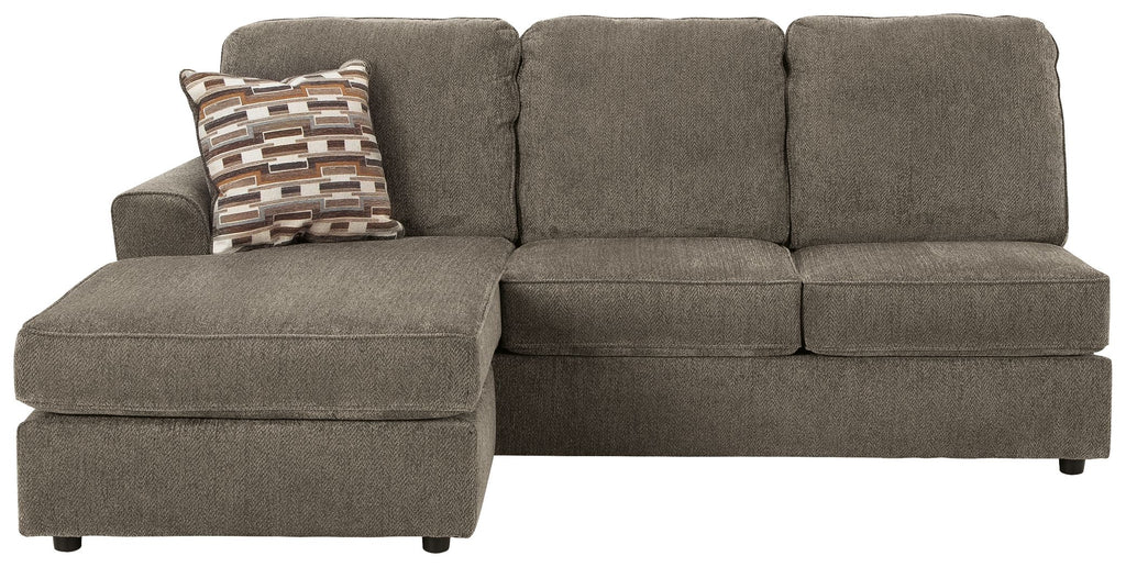 Gray sofa chaise with chaise extension, tufted back cushions, and patterned throw pillow