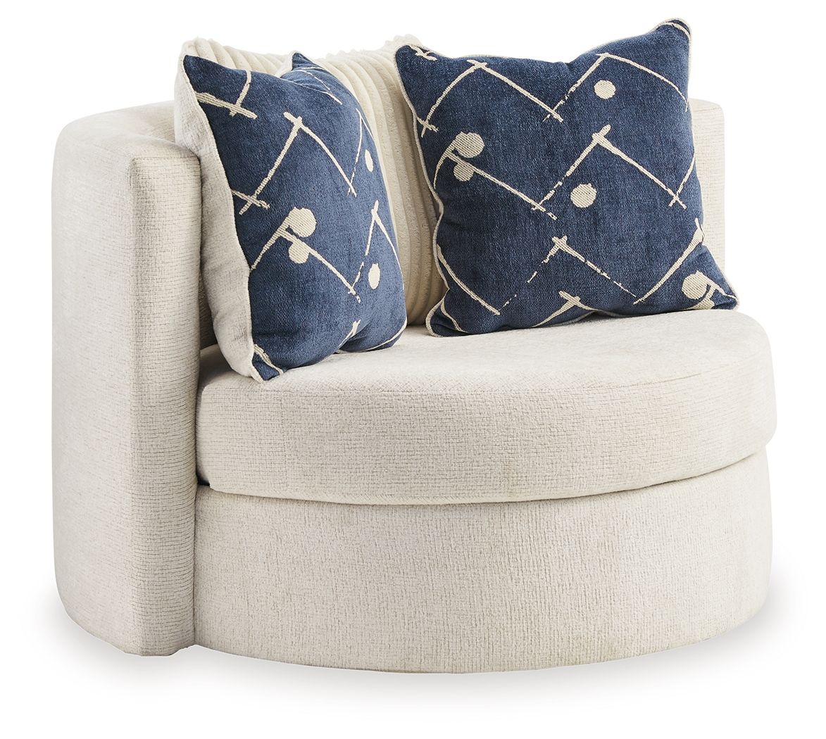 Ivory swivel accent chair with two navy patterned throw pillows, round arms and padded seat