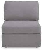 Gray armless chair with tall backrest and padded seat, upholstered in textured fabric