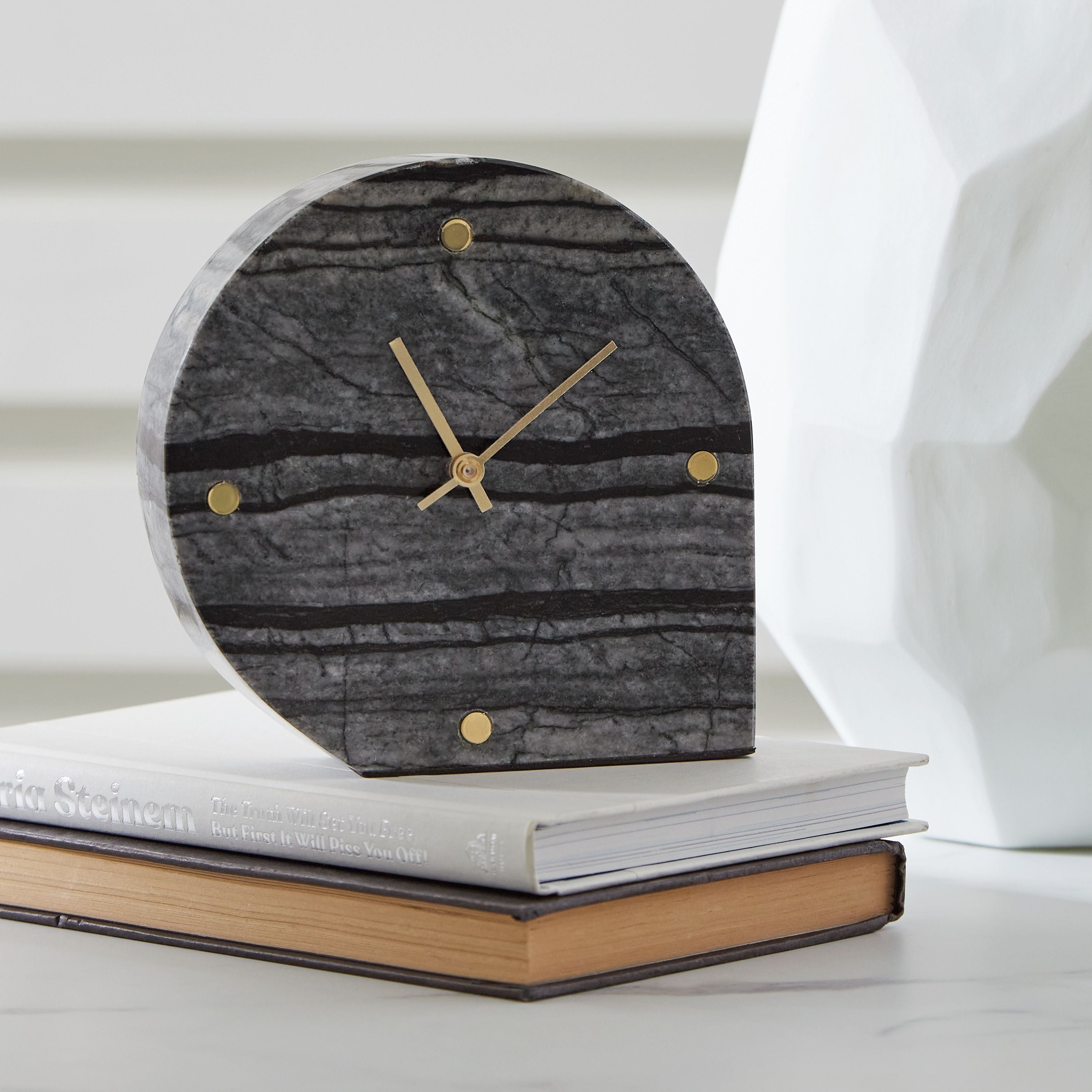 Table clock, dark gray arched face with gold hands and dot markers