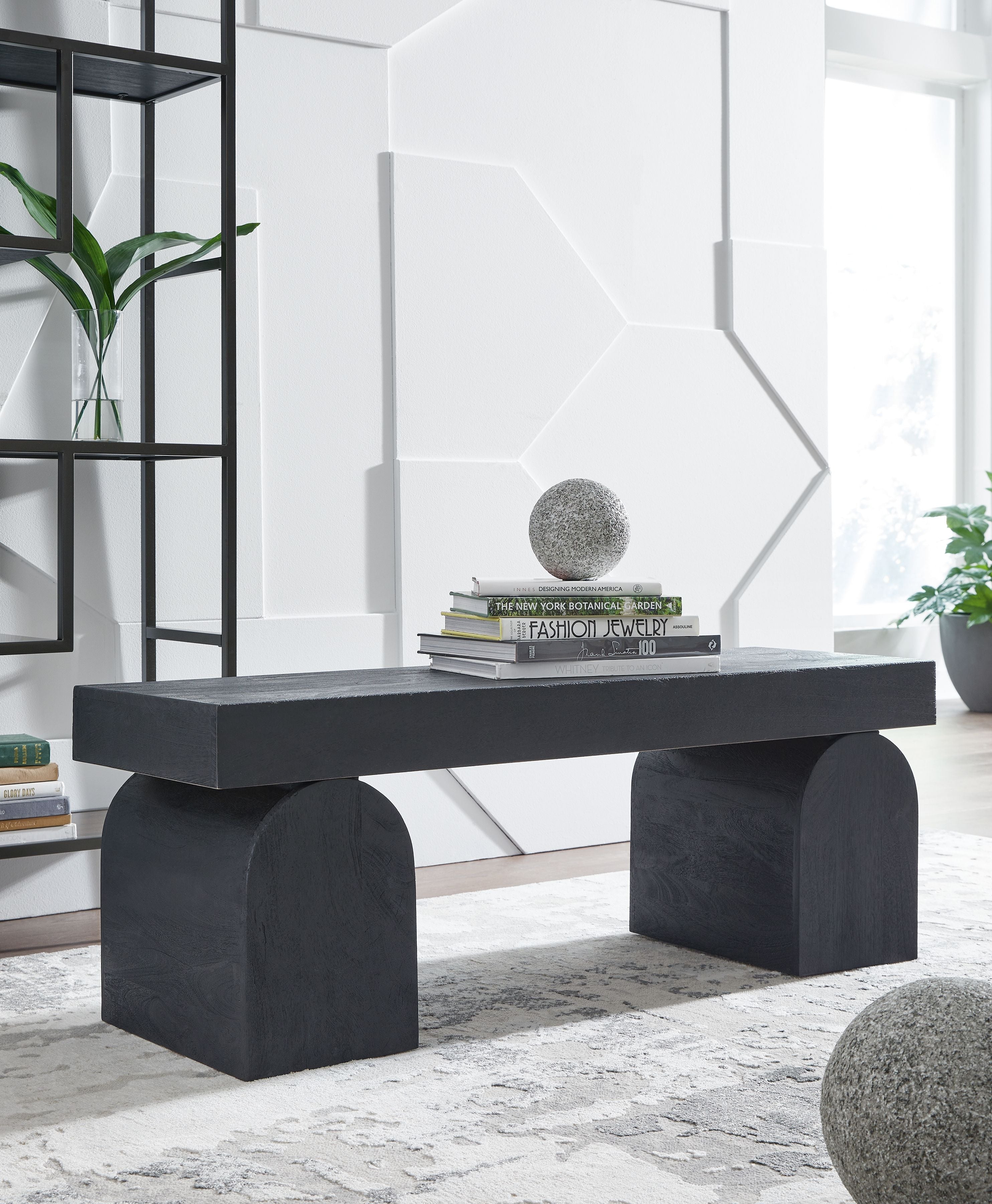 Black accent bench with wide rectangular top and two chunky block legs