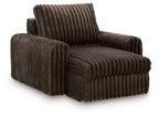 Dark chocolate corduroy chaise lounge with tall backrest and rounded arms