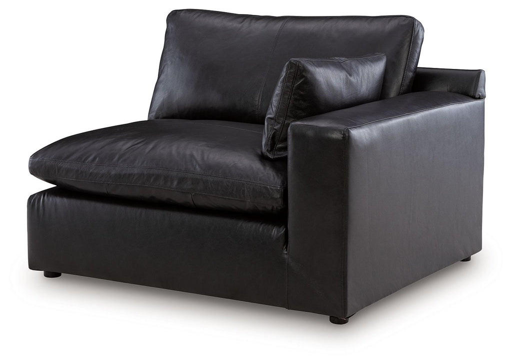 Black RAF corner chair with padded arms and seat cushions, vinyl upholstery