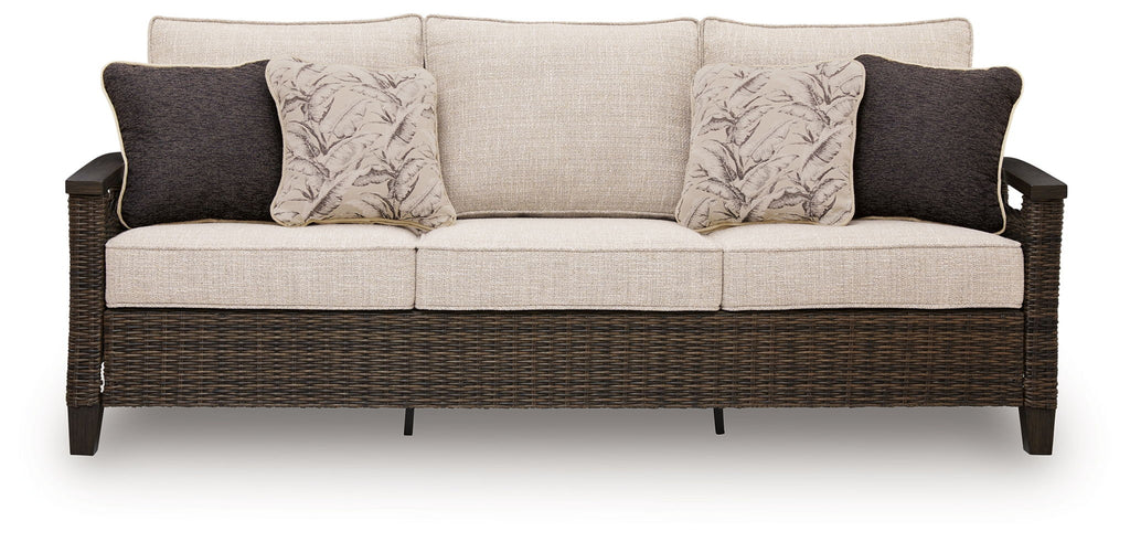 Dark brown wicker sofa with light gray cushions and two dark back pillows