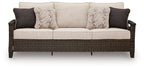 Dark brown wicker sofa with light gray cushions and two dark back pillows