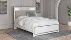 Queen bed with white frame and light-gray tufted headboard with roll-slat design