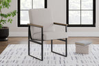 Light beige upholstered armchair with wood armrests and dark metal legs