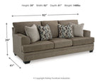 Stonemeade sofa in dark taupe fabric with two geometric accent pillows and two solid cushions