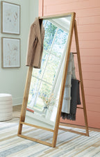 Brown wooden floor mirror leaning with full-length rectangular glass
